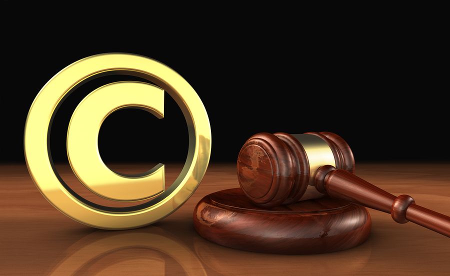Copyright intellectual property and digital copyright laws conceptual illustration with symbol and icon and a gavel on black background.